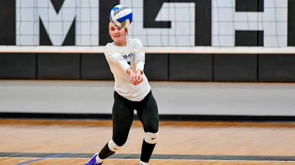 Volleyball player hitting ball